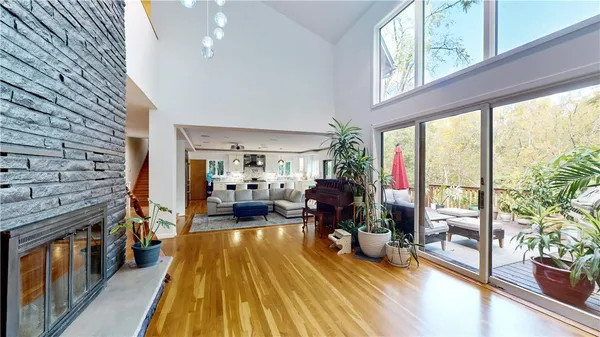 a living room with furniture stove and wooden floor