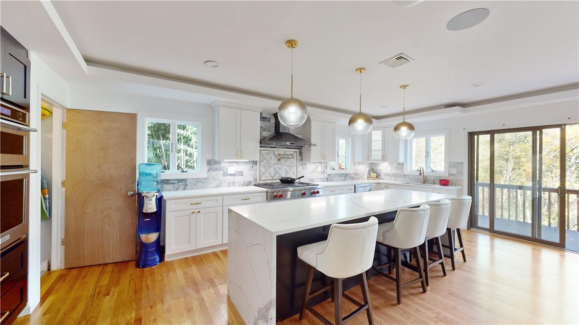 96 Old Pascack Road Pearl River, NY 10965 - Photo 9 of 36 a large kitchen with a table and chairs