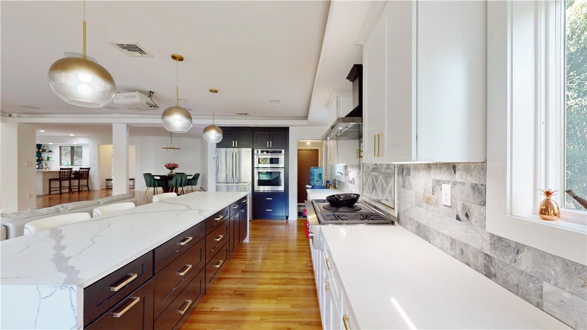 96 Old Pascack Road Pearl River, NY 10965 - Photo 10 of 36 a large white kitchen with kitchen island a large counter space a sink a window and stainless steel appliances