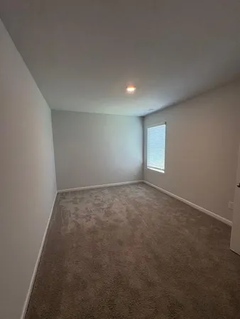 an empty room with a empty space and windows