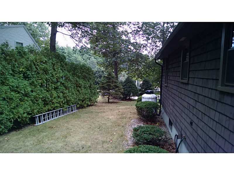 161 Colonial Road Burrillville, RI 02830 - Photo 3 of 22 Exterior Back. back yard well maintained landscaping. Hedges along property line