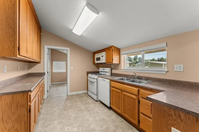 a kitchen with a stove a sink and a refrigerator