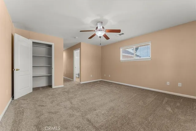 a view of empty room with ceiling fan
