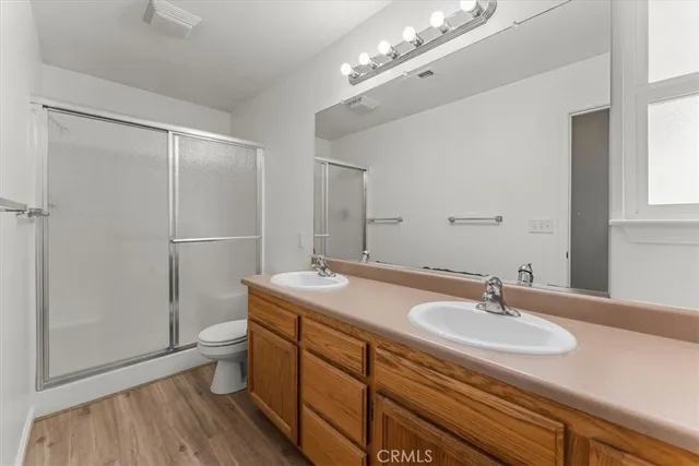 a bathroom with a sink double vanity granite and shower