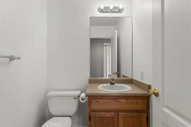 a bathroom with a sink toilet and mirror