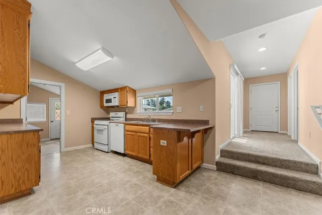 a kitchen with stainless steel appliances granite countertop a stove and a refrigerator