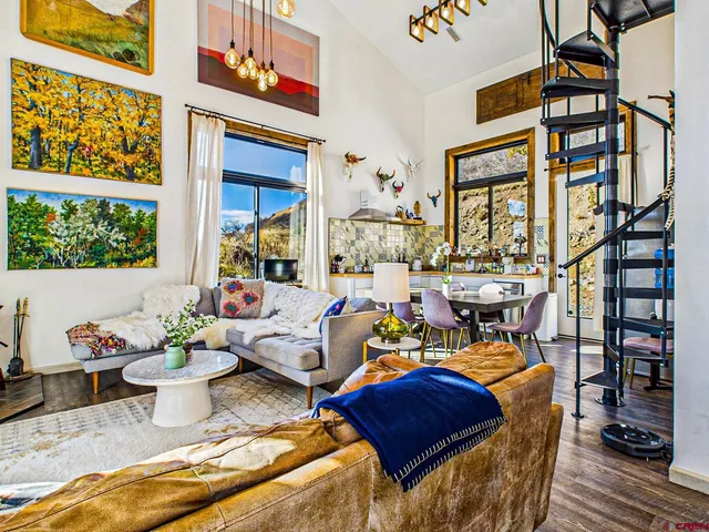 a living room with furniture fireplace and a large window