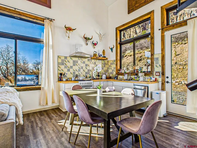 a view of a dining room with furniture large window and wooden floor
