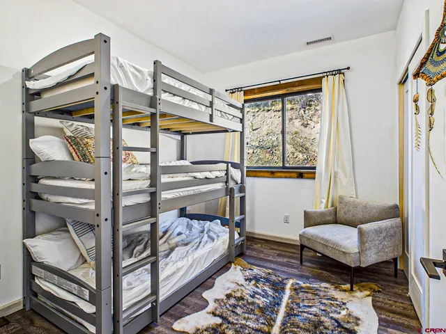 a bedroom with furniture and a window