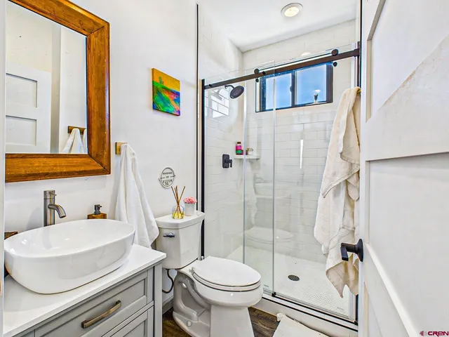 a bathroom with a sink toilet and shower