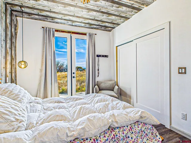 a bedroom with a bed and a window