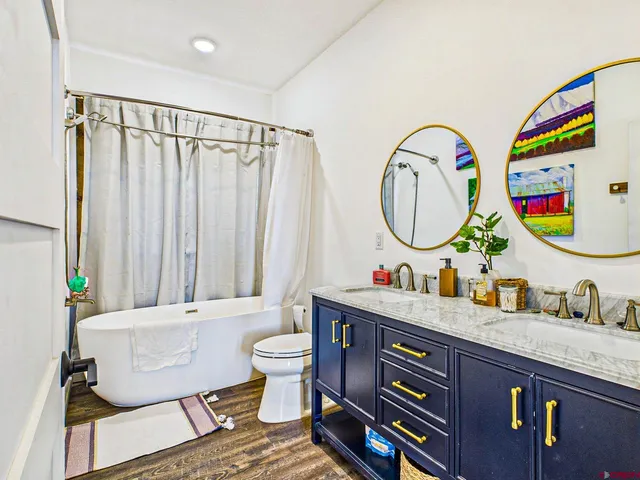 a bathroom with a toilet a sink and a mirror