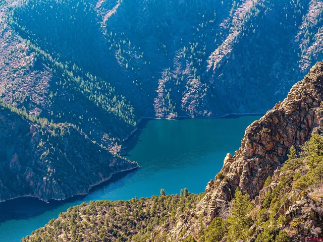 a view of a large building with mountains in the background