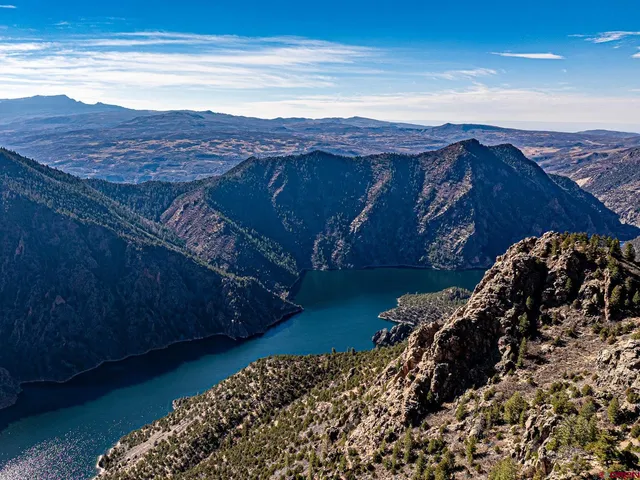 a bed sitting in a bedroom next to a lamp