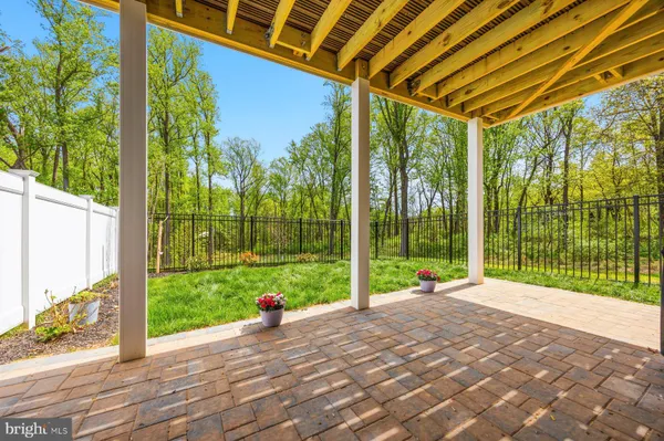 a large kitchen with lots of counter top space a sink stainless steel appliances and cabinets
