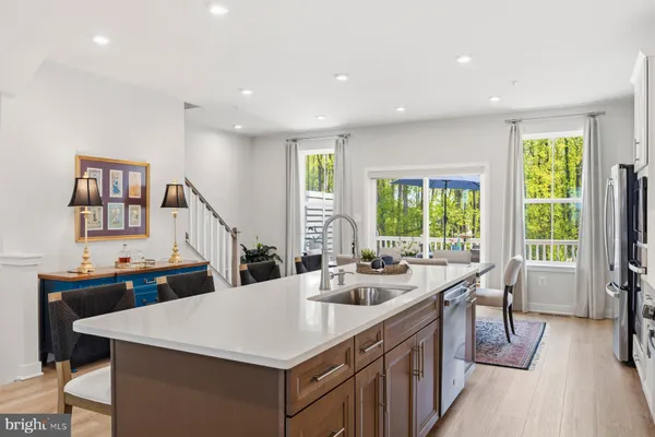 a kitchen with a sink a counter top space and a large window