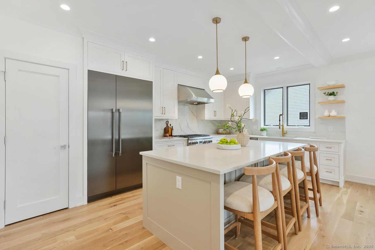 a kitchen with a dining table cabinets and stainless steel appliances