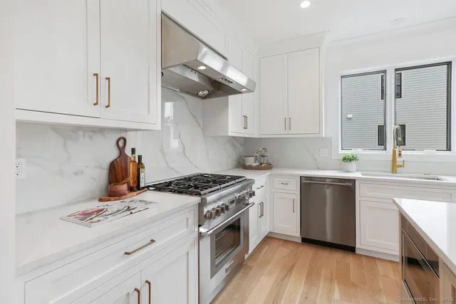 a kitchen with a stove oven and sink