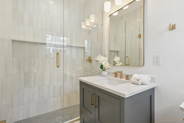 a bathroom with a sink vanity and a mirror