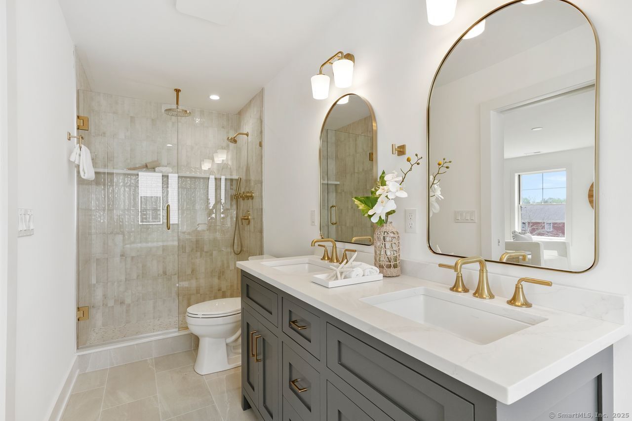 345 Reef Road, Unit B6 Fairfield, CT 06824 - Photo 20 of 40 a bathroom with a double vanity sink mirror and toilet