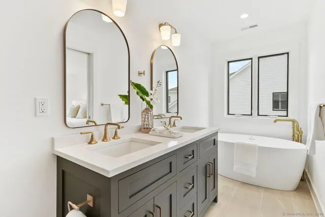 a bathroom with a double vanity sink and a mirror