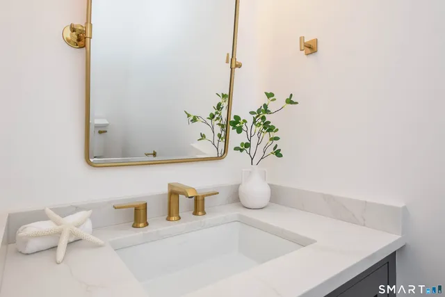 a bathroom with a sink a vanity and mirror
