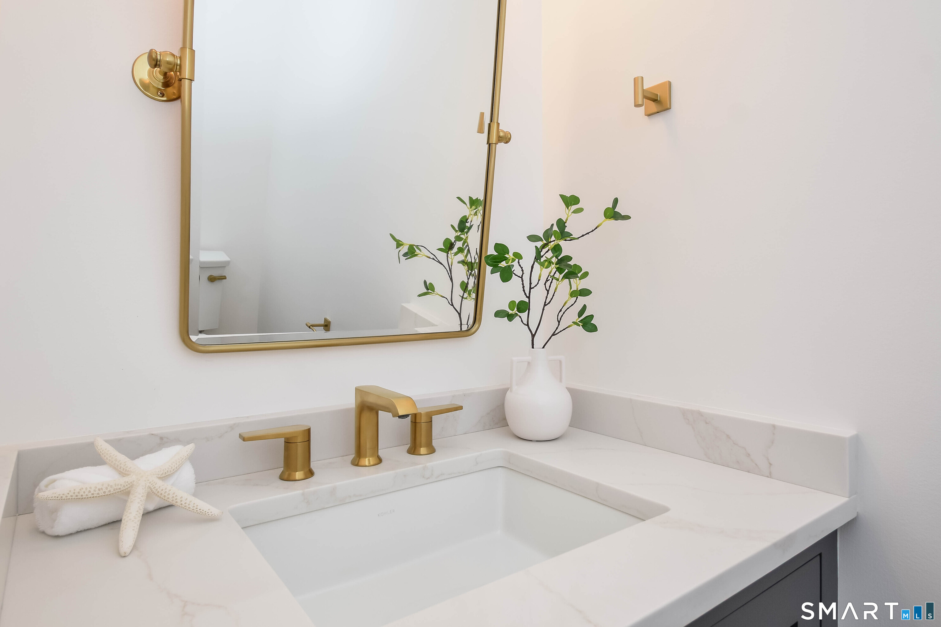 345 Reef Road, Unit B6 Fairfield, CT 06824 - Photo 34 of 40 a bathroom with a sink a vanity and mirror