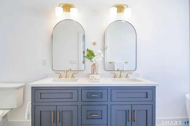 a bathroom with a double vanity sink and a mirror