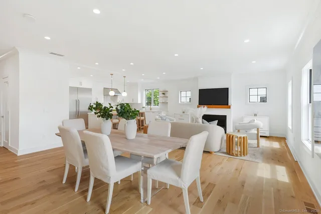 a view of a dining room with furniture wooden floor and a flat screen tv