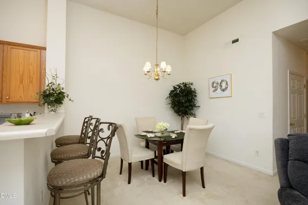a view of a dining room with furniture and a potted plant
