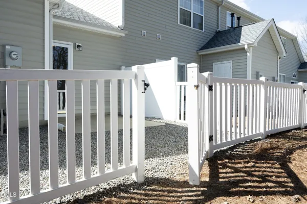 a view of a house with wooden fence