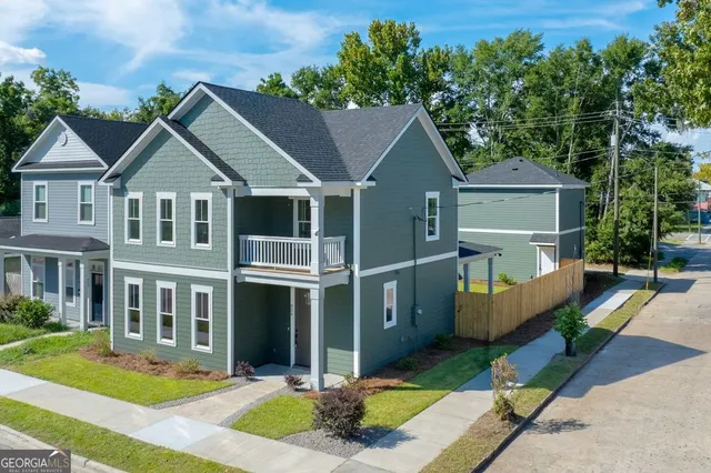 a front view of a house with a yard table and chairs