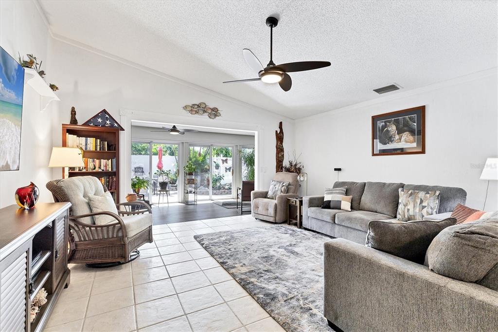 6304 Pelican Drive Bradenton, FL 34210 - Photo 17 of 42 a living room with furniture and a floor to ceiling window