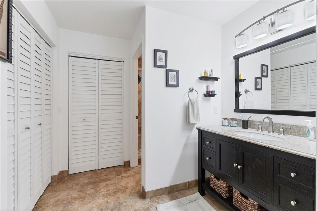 6304 Pelican Drive Bradenton, FL 34210 - Photo 21 of 42 a bathroom with a double vanity sink and mirror