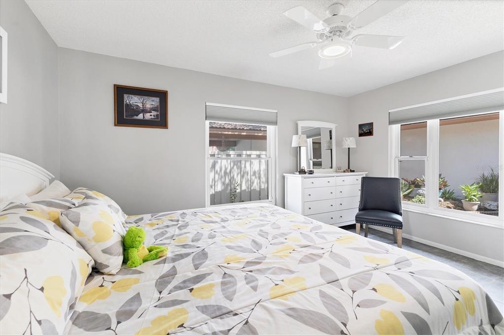 6304 Pelican Drive Bradenton, FL 34210 - Photo 24 of 42 a bedroom with a bed and a chandelier