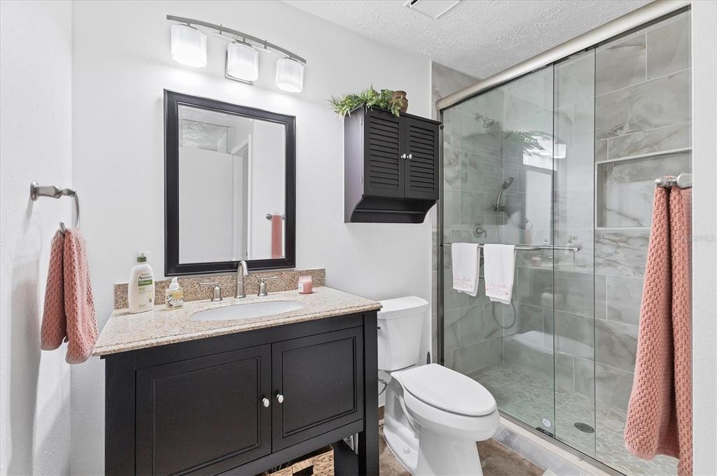 6304 Pelican Drive Bradenton, FL 34210 - Photo 25 of 42 a bathroom with a sink a toilet and shower