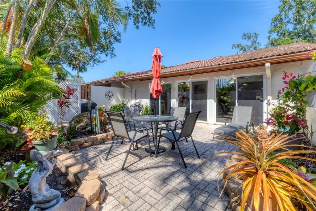 6304 Pelican Drive Bradenton, FL 34210 - Photo 30 of 42 a view of a patio with table and chairs and potted plants