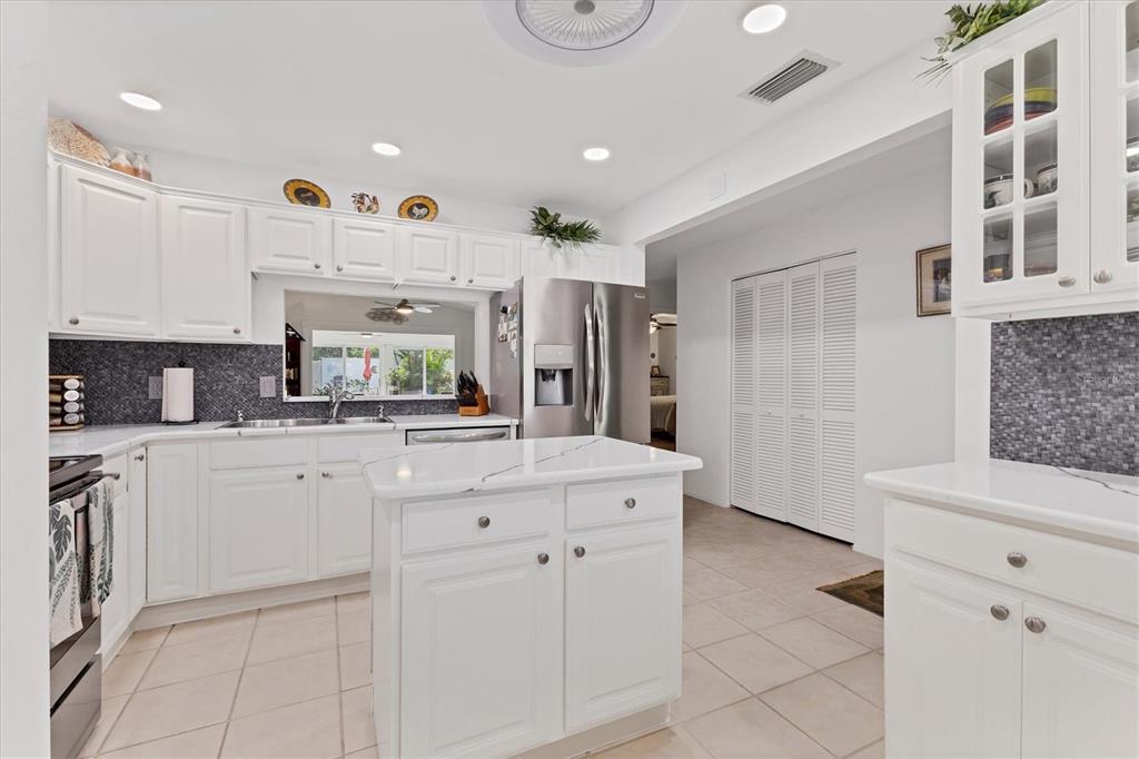 6304 Pelican Drive Bradenton, FL 34210 - Photo 9 of 42 a large white kitchen with cabinets