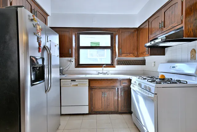 a kitchen with a stove sink and refrigerator