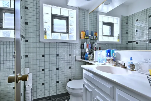 a white toilet sitting next to a bathroom sink