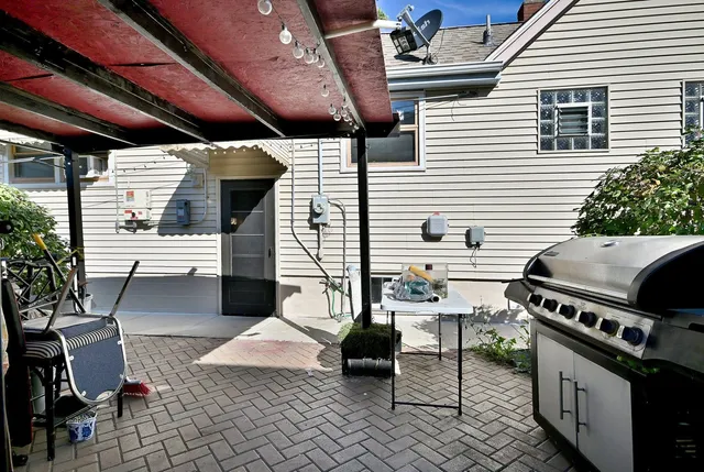 a view of a patio with table and chairs potted plants with wooden floor and fence