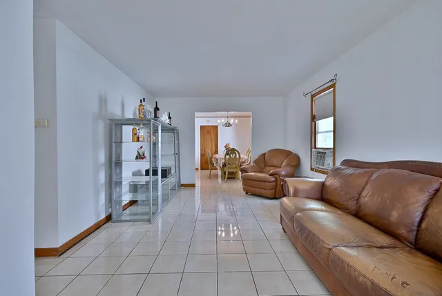 a living room with furniture and stairs