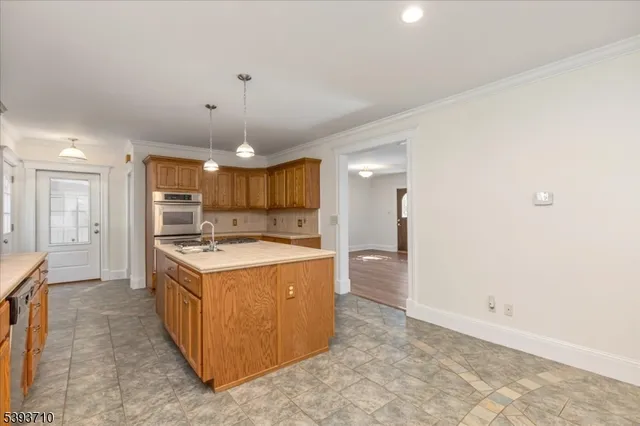 a large kitchen with a stove and a refrigerator
