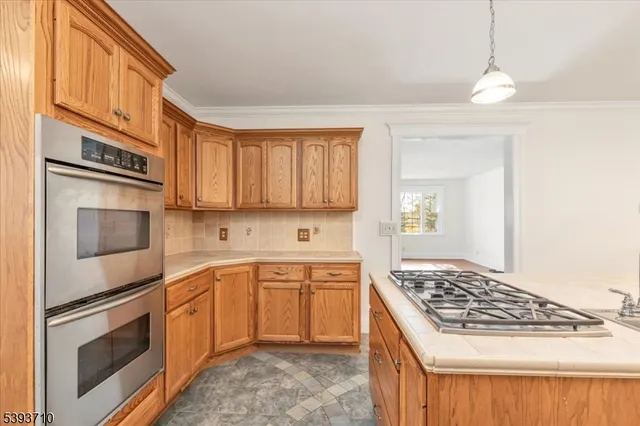 a kitchen with stainless steel appliances granite countertop a stove and a sink
