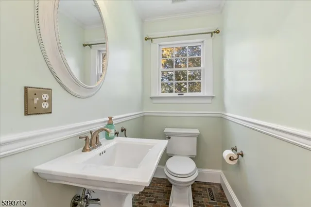 a bathroom with a sink toilet and a mirror