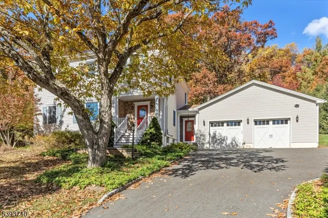 a view of a house next to a road and yard