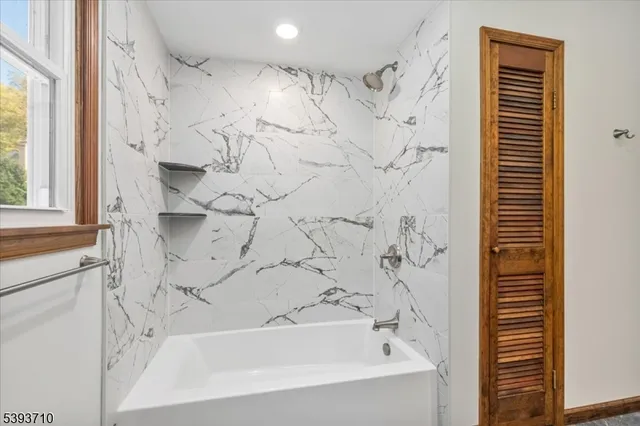 a bathroom with a bathtub and shower