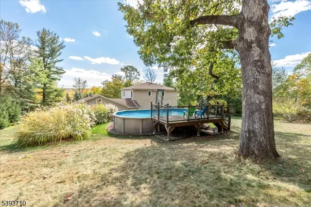 a view of a house with yard and sitting area