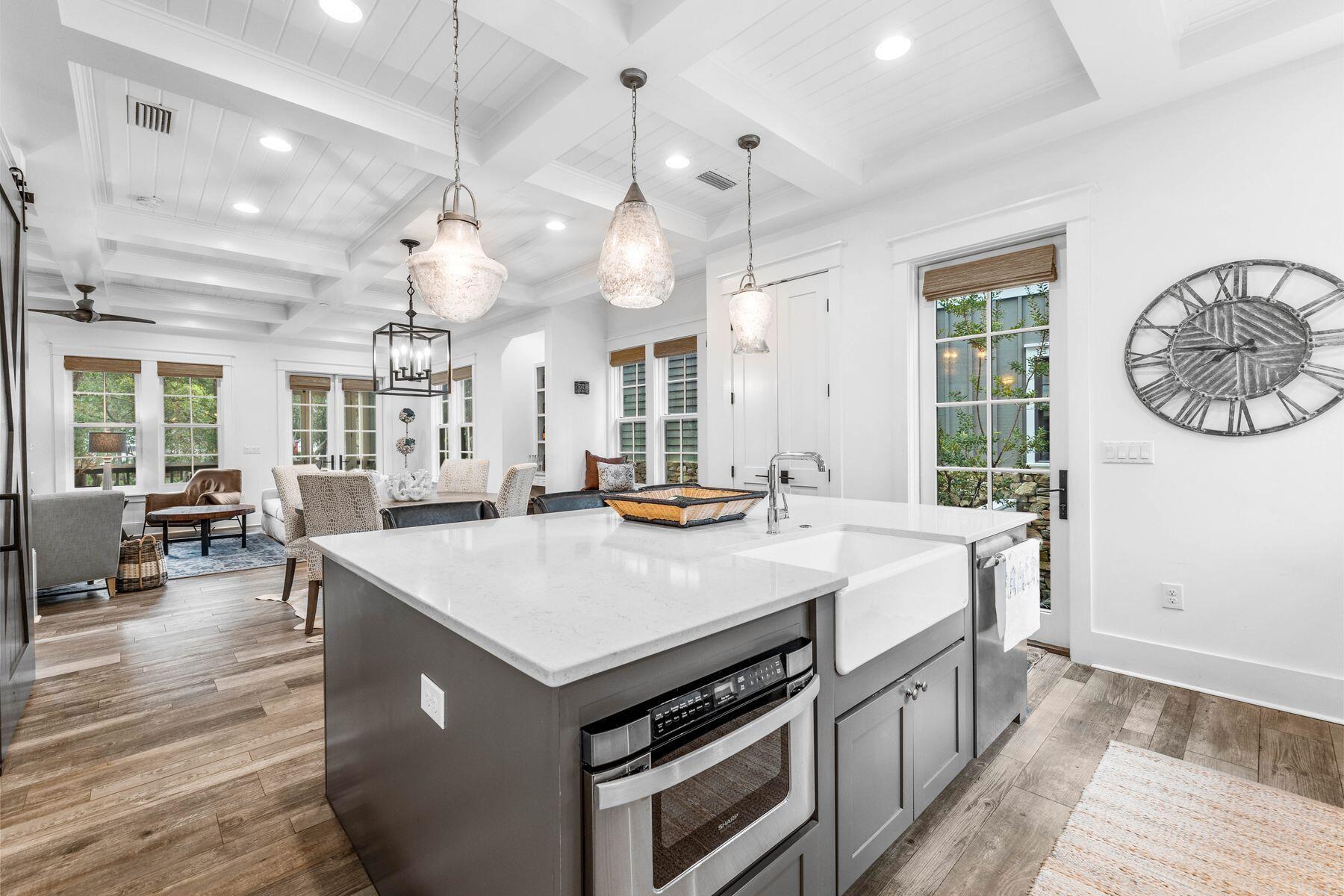 79 Cedar Post Road Santa Rosa Beach, FL 32459 - Photo 11 of 55 a kitchen with a stove a clock and wooden floor