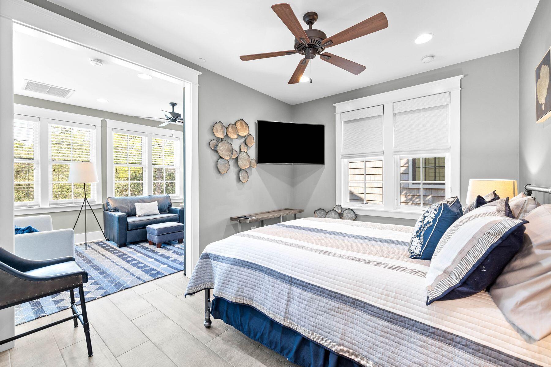 79 Cedar Post Road Santa Rosa Beach, FL 32459 - Photo 38 of 55 a bedroom with a bed a couch and a flat screen tv with wooden floor